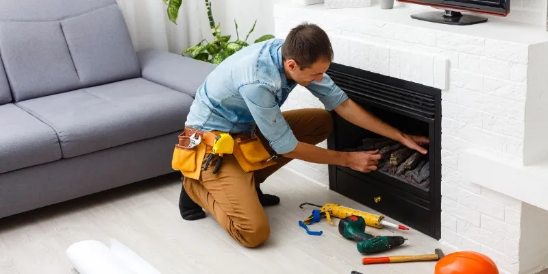 a professional doing fireplace maintenance